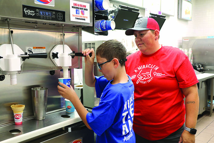 Blaze Dunn making blizzards with Morgan Kerr at Moosomin Dairy Queen on Miracle Treat Day last year.